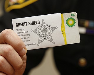        ROBERT K. YOSAY  | THE VINDICATOR.. Sheriff Jerry Greene inserting a credit card into a protective sleeve to prevent RFID skimming. The sheriffÕs office is giving two free sleeves to anyone who wants them to prevent identity theft. TheyÕre funded by drug forfeiture money...-30-