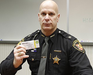        ROBERT K. YOSAY  | THE VINDICATOR.. Sheriff Jerry Greene inserting a credit card into a protective sleeve to prevent RFID skimming. The sheriffÕs office is giving two free sleeves to anyone who wants them to prevent identity theft. TheyÕre funded by drug forfeiture money...-30-