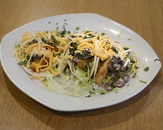 Katie Rickman | The Vindicator.Mahi Mahi Tacos at Calle Doce is served lettuce, pico de gallo and a spicy cream sauce and runs for $6.99.  Brothers in Food, Mark Smesko and Mike Vallas visit the Campbell Puerto Rican style resteraunt on Saturday, Nov. 22, 2014.