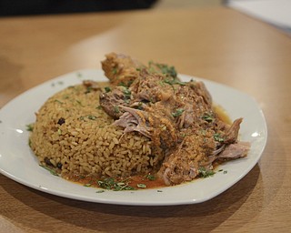 Katie Rickman | The Vindicator.Pernil y y arroz con gandules features roasted pork, Puerto Rican rice and pigeon peas and runs  at $9.99.