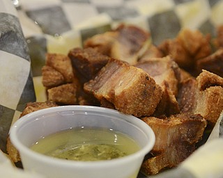 Katie Rickman | The Vindicator.Chicharrones- a traditional Puerto Rican meal features fried pork, Puerto Rican rice and pigeon peas and is served with salad runs at $9.99.