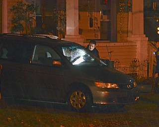 Katie Rickman | The Vindicator .Officials survey the scene of a suspected homicide on the 700 block of Lexington Avenue in Youngstown Sunday night.