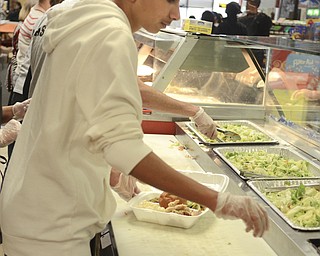 Katie Rickman | The VindicatorMazin Musleh 14, of Youngstown prepares a to-go turkey dinner at the Downtown Circle Deli in Youngstown where he and other volunteers served over 200 boxed dinners.
