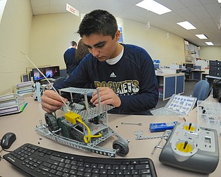 Jeff Lange | The Vindicator  Lowellville junior Tony Nakley makes adjustments to his robot  during class, Friday morning.