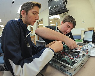 Jeff Lange | The Vindicator  Vince Hensperger (left) and Vince Donofrio (right) work on their robots, Friday morning during class at Lowellville High School.