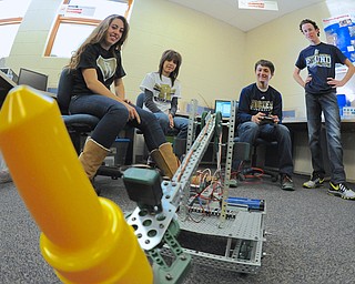 Jeff Lange | The Vindicator  Robotics II students Anne Piccirillo (left), Andi Hrusovsky (left center), Nick Piccirillo (right center) and Van Over (far right) watch as their robot picks up a yellow cone during class, Friday morning at Lowellville High School.