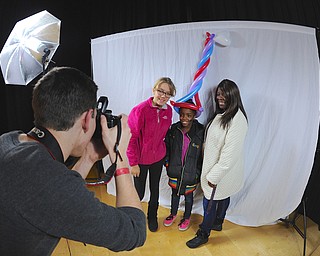 Jeff Lange | The Vindicator  Amy Hileman (14 left), Love Sherman (10 center) and Lucinda Sherman (right) of Youngstown pose for a portrait as photographer Brandon Hetherington of Warren snaps the photo during Saturday's Day of Hope at Wilson Middle School.