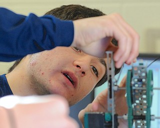 Jeff Lange | The Vindicator  Nick Piccirillo, senior at Lowellville makes adjustments to his robot during Robotics II class, Friday morning.