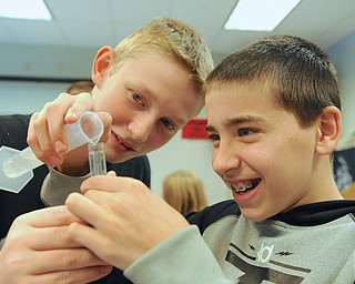 Jeff Lange | The Vindicator  Billy Opritza (left) and Jake Ryan (right) smile as they pour water into a test tube, Friday afternoon at Strutters Middle School.