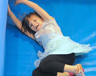 Jeff Lange | The Vindicator  Marie Frazier (7) of Youngstown slides down the bounce slide during Saturday afternoon's Day of Hope held at Wilson Middle School. Marie is the daughter of Robin and Melissa Frazier.