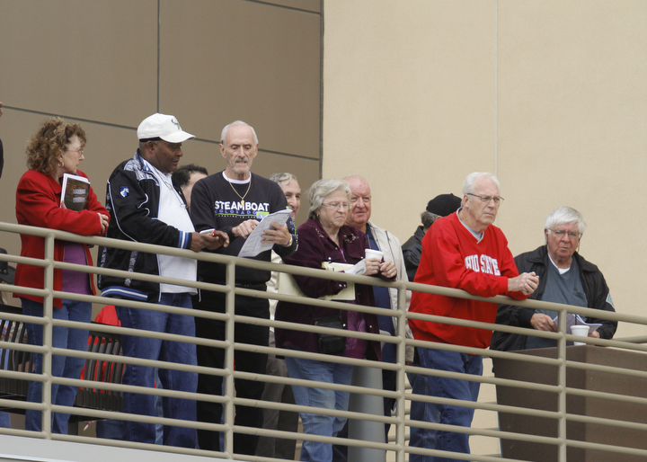        ROBERT K. YOSAY  | THE VINDICATOR..Windy but warm temperatures had the Hollywood Gaming Racino parking lot filled as people came out to watch the inagural run of thoroghbred racing in the Mahoning Valley...The second floor loft / balcony look down on the paddock and the race horses.
