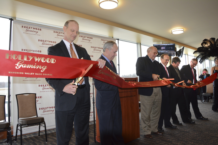        ROBERT K. YOSAY  | THE VINDICATOR..Windy but warm temperatures had the Hollywood Gaming Racino parking lot filled as people came out to watch the inagural run of thoroghbred racing in the Mahoning Valley...Mike Galle VP and GM- Mark J Loewe  VP of  racing  Robert K Schmitz .... Mark Monroe   Dave Basler -  and Jim Davis.
