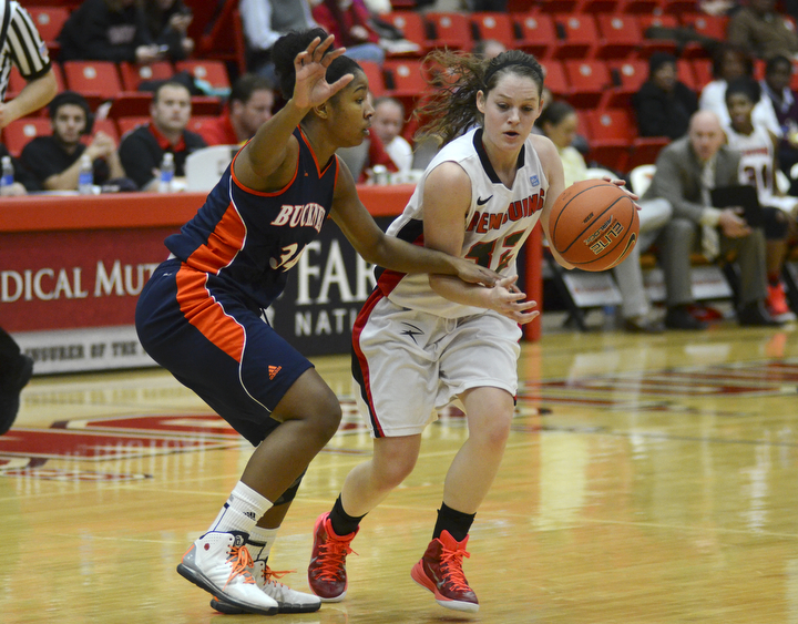 Katie Rickman | The Vindicator.Youngstown State's Jenna Hirsch pushes past Bucknell's Sheaira Jones (34) during the first period of the game at the Beeghly Center on Tuesday, Nov. 25, 2014.