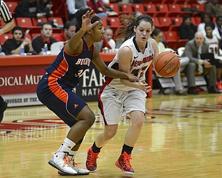 Katie Rickman | The Vindicator.Youngstown State's Jenna Hirsch pushes past Bucknell's Sheaira Jones (34) during the first period of the game at the Beeghly Center on Tuesday, Nov. 25, 2014.