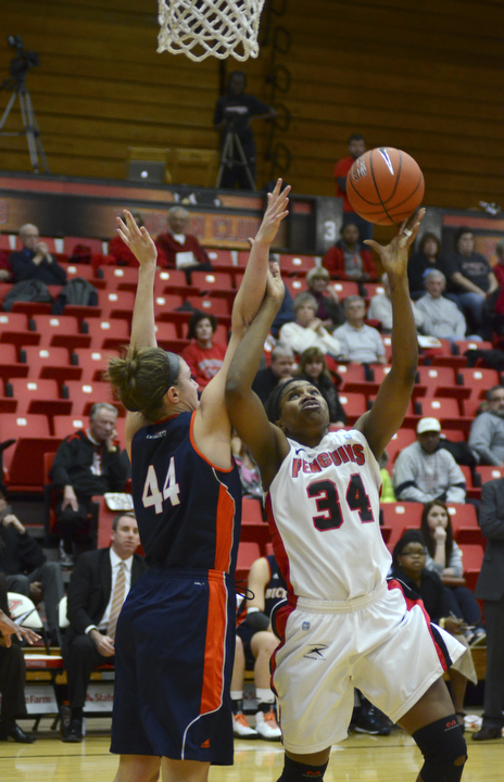 Katie Rickman | The Vindicator.Youngstown State's Latisha Walker (34) goes up for a basket as Bucknell's Audrey Dotson (44) attempts to block her in the first period at the Beeghly Center on Tuesday, Nov. 25, 2014.