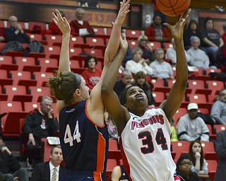 Katie Rickman | The Vindicator.Youngstown State's Latisha Walker (34) goes up for a basket as Bucknell's Audrey Dotson (44) attempts to block her in the first period at the Beeghly Center on Tuesday, Nov. 25, 2014.