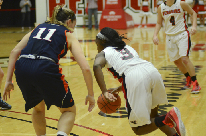 Katie Rickman | The Vindicator.Youngstown State's Indiya Benjamin goes around Bucknell's Megan McGurk (11) during the first period during the game at the Beeghly Center on Tuesday, Nov. 25, 2014.