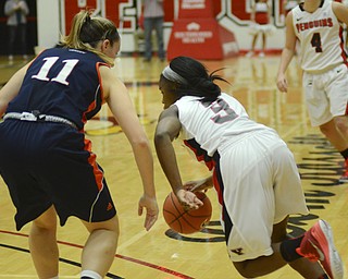 Katie Rickman | The Vindicator.Youngstown State's Indiya Benjamin goes around Bucknell's Megan McGurk (11) during the first period during the game at the Beeghly Center on Tuesday, Nov. 25, 2014.
