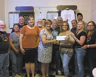 Melissa Kalaman, third from right, chairwoman of the Mike Hull Memorial Poker Run, presents a $2,300 check to Aundrea Cika, center, director of the Mahoning Valley Office of the Autism Society of Ohio, and Jen Gonda, third from left, also of the autism society. Some 60 motorcyclists participated in the second annual poker run and pasta dinner in August to benefit autism. Kalaman is the sister of the namesake of the event, established in 2013 to honor Hull, grandfather to a granddaughter on the autism spectrum. Proceeds will be used to establish a holiday family and minigrant program for Valley families. Others are committee members. Special to The Vindicator 