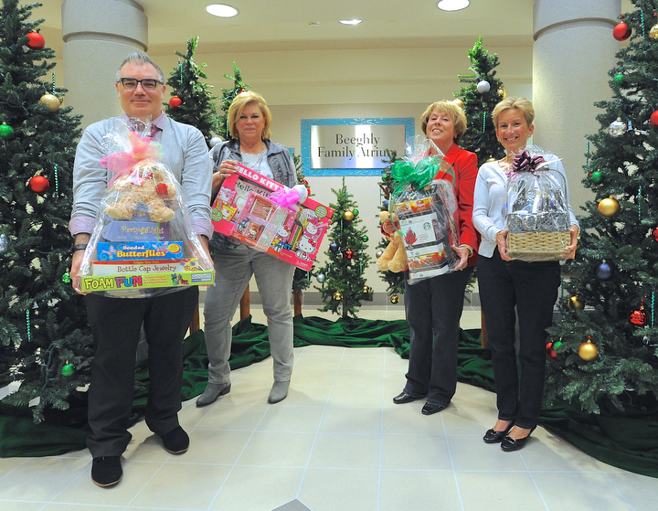 Jeff Lange | The Vindicator  From Dennis Dively Dillards visual merchandiser, Debbie Shattuck of DMW Insurance, Donna Hayat and Kathy Dwinnells of Hopes and Wishes stand in front of the Christmas display at Akron Childrens of Mahoning Valley.