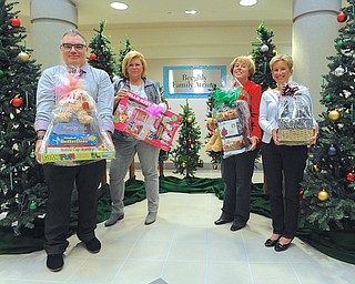 Jeff Lange | The Vindicator  From Dennis Dively Dillards visual merchandiser, Debbie Shattuck of DMW Insurance, Donna Hayat and Kathy Dwinnells of Hopes and Wishes stand in front of the Christmas display at Akron Childrens of Mahoning Valley.