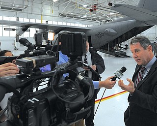 Jeff Lange | The Vindicator  Senator Sherrod Brown speaks to press about future intentions of upgrading the C-130 Hercules airplanes at the Youngstown Air Reserve Base in Vienna, Monday morning in the hangar. Upgrades must be made by the year 2020 in order for the planes to meet federal and international standards.
