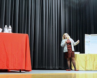 Jeff Lange | The Vindicator  Kylie Thomas (center) tells the judges (left) how group 12's restaurant will provide low prices to it's customers while still providing high quality meals as group members Madeline Barbato, Anthony D'Apruzzo and Anthony Bennett look on at the display from the right during Struthers Middle School's "Wildcat Cage" a spinoff of the TV show Shark Tank, Monday afternoon.