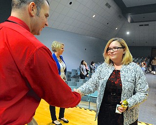 Jeff Lange | The Vindicator  8th grader at Struthers Kylie Thomas shakes the hand of Principle Pete Pirone (left) after being awarded first place for her group's restaurant after Struthers Middle School's "Wildcat Cage" a spinoff of the TV show Shark Tank, Monday afternoon.