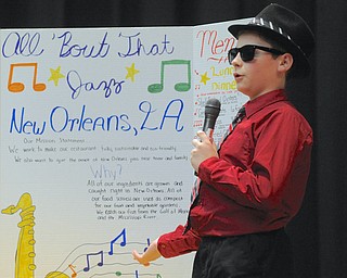Jeff Lange | The Vindicator  Brett Novits tells the judges about the presence of Jazz music in his group's restaurant in New Orleans during Struthers Middle School's "Wildcat Cage" a spinoff of the TV show Shark Tank, Monday afternoon.