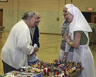 Katie Rickman | The Vindicator.Ruth and Bob Bolan of Youngstown joke with Sister Sister Maria Karas (left) and Alexandra Klimovich who are from Eastern Europe (Belarus) on Tuesday, Nov. 25, 2014 at the Father Snock Center at Our Lady of Sorrows Parish in Youngstown.