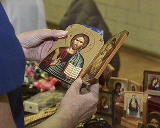 Katie Rickman | The Vindicator.A woman looks at a handcrafted portrait of Jesus that is being sold by two nuns from Eastern Europe on Tuesday, Nov. 25, 2014.