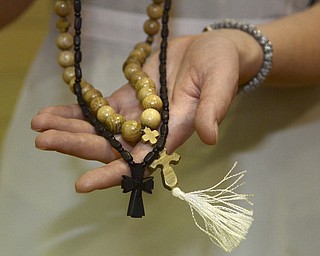 Katie Rickman | The Vindicator.Sister Alexandra shows handcrafted rosaries that she and Sister Maria sold at Our Lady of Sorrows Parish in Youngstown on Tuesday, Nov. 25, 2014.