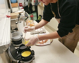        ROBERT K. YOSAY  | THE VINDICATOR.. Canfield HS students meet for 30 minutes before school to attain extra credit....  at the Cardinal Cafe enterprise  Ryan Jones cooks up an egg for a sandwich -