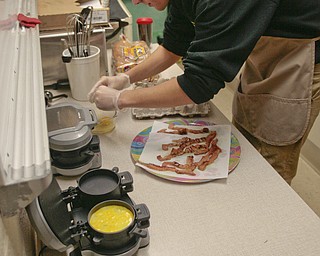        ROBERT K. YOSAY  | THE VINDICATOR.. Canfield HS students meet for 30 minutes before school to attain extra credit....  at the Cardinal Cafe enterprise  Ryan Jones cooks up an egg for a sandwich -