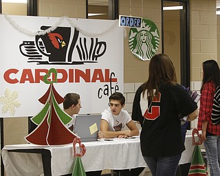        ROBERT K. YOSAY  | THE VINDICATOR.. Canfield HS students meet for 30 minutes before school to attain extra credit....  .cardinal cafe as Anthony Vross sophmore and Nick Phillips a junior monitor the desk and orders .