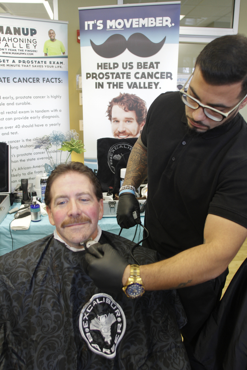        ROBERT K. YOSAY  | THE VINDICATOR..  A  little off the chin as  Patrick WIilson - gets his beard shaved by Excalibur Barber Grooming Lounge.  employee  Eithyer Ramos ..Mercy Health Youngstown, formerly Humility of Mary Health Partners, Man Up Mahoning Valley, Mercy Health Youngstown Cancer Centers, Mercy Health Foundation, NEO Urology and Partners for Urology Health will close out ÔMovemberÕ with an official shave-off at