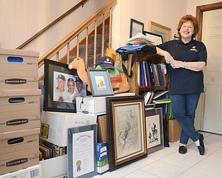 Katie Rickman | The Vindicator.Diana Colaianni leans against a bookshelf that is among boxes that are being moved from her office as MC Health Director of Nursing on Tuesday, Nov. 25, 2014.  The boxes along the wall are just a portion of boxes containing everything collected over the 19 years.