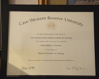 Katie Rickman | The Vindicator .After years of hanging in her office, Diana Colaianni's diploma from Case Western Reserve University rests on top of the shelf in her walkway of her Boardman home along with many other boxes on Tuesday, Nov. 25, 2014.