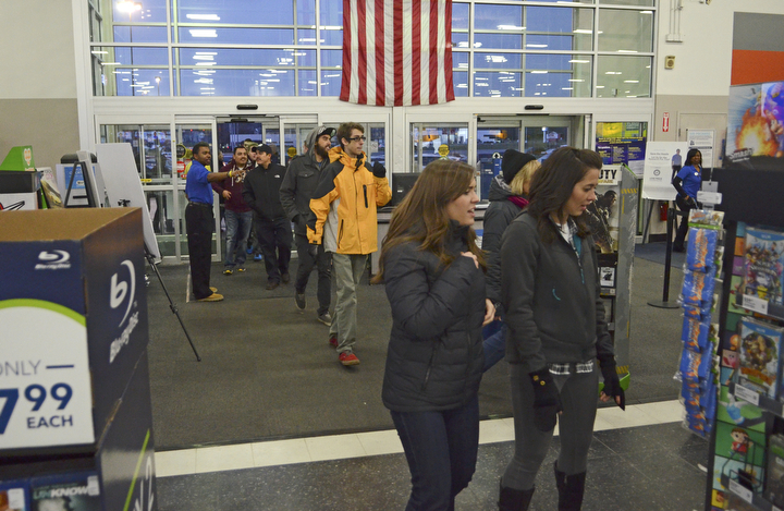 Katie Rickman | The Vindicator.After waiting in a line for hours, customers walk through the doors at 5pm when Best Buy began their Thanksgiving Day sale on Thursday, Nov. 27, 2014 in Boardman.