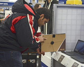 Katie Rickman | The Vindicator.Rinkeh Prajapati of Eerie, Pennsylvania looks at a lap top at Best Buy in Boardman during the Thanksgiving Day sale on Thursday, Nov. 17, 2014.