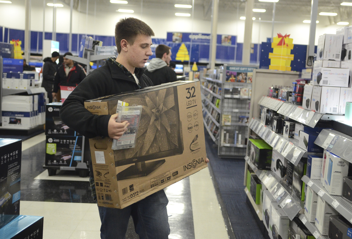 Katie Rickman | The Vindicator.Evan Noll 17 of Boardman holds a 32" Insignia TV as he shops at Best Buy for their Thanksgiving Day sale on Thursday, Nov. 27, 2014.