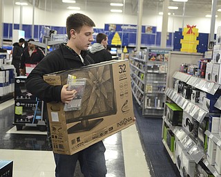 Katie Rickman | The Vindicator.Evan Noll 17 of Boardman holds a 32" Insignia TV as he shops at Best Buy for their Thanksgiving Day sale on Thursday, Nov. 27, 2014.