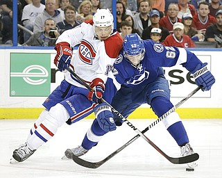 Canadiens left wing Rene Bourque (17) battles Lightning defenseman Andrej Sustr (62) for the puck during the Stanley Cup Playoff s game in Tampa, Fla. Sustr played for the Youngstown Phantoms during the 2009-10 season.