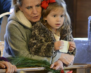 Katie Rickman | The Vindicator.Sherri Smidt of Poland holds her granddaughter Hadlee .DeSalvo 3, of Boardman as they lean against a railing inside of Lanternman's Mill during Mill Creek Park's Olde Fashioned Christmas on Saturday, Nov. 29, 2014.