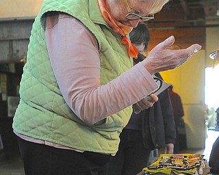 Jeff Lange | The Vindicator  Cynthia Schlosser of Poland browses the selection of pendants at the art show that was held at the Ward Bakery, Saturday afternoon.