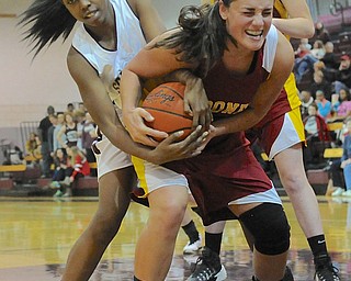 Jeff Lange | The Vindicator  Boardman's Doricia Robinson (left) and Mooney's Jaclyn Yankle (right) fight under the basket for a rebound in the second period of their matchup, Saturday evening at Boardman High School.