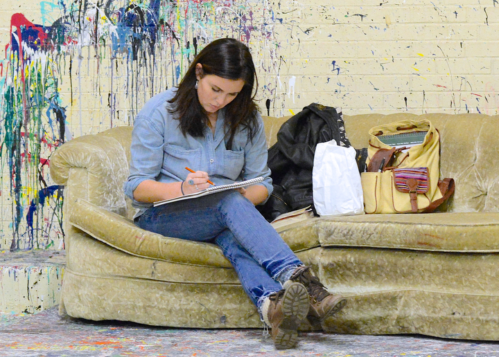 Jeff Lange | The Vindicator  Artist Rachel Wilson of Dayton sits on the couch in her studio as she sketches during Saturday's open studio and art sale at the Ward Bakery.