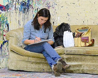 Jeff Lange | The Vindicator  Artist Rachel Wilson of Dayton sits on the couch in her studio as she sketches during Saturday's open studio and art sale at the Ward Bakery.