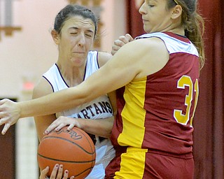 Jeff Lange | The Vindicator  Boardman's Anna Saxton (left) rams into the defense of Mooney's Samantha Ellis (31) during first period action of their game Saturday night at Boardman High School.