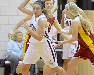 Jeff Lange | The Vindicator  Boardman's Jenna Vivo (front left) bobbles the ball above her head as she makes her way through two Mooney players Samantha Ellis (back left) and Kelly Williams (front right) in the first half of Saturday night's game in Boardman.